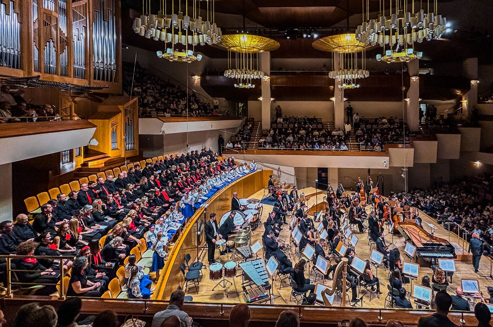 A full orchestra and choir performing at the National Auditorium in Madrid.